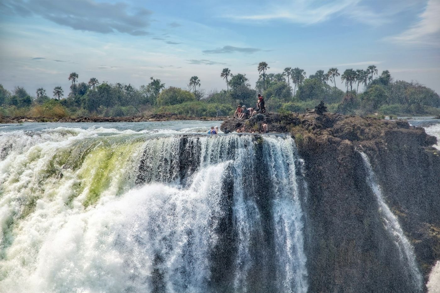 Swimmers at the very edge of Victoria Falls