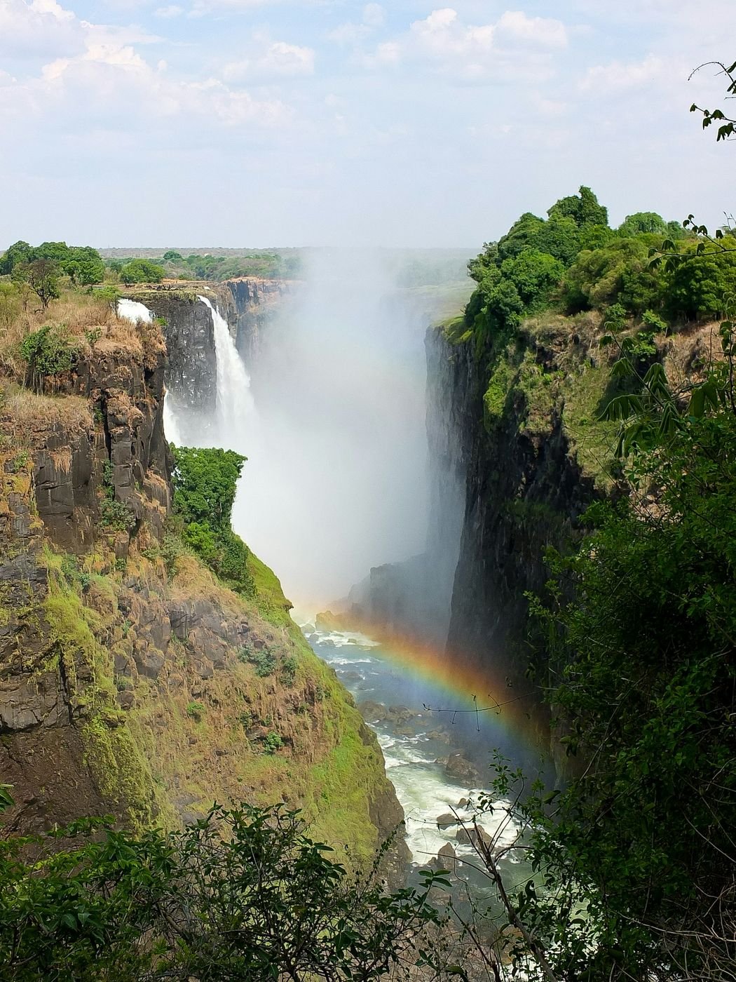 Rainbow in the spray at Victoria Falls, seen from the rainforest walk